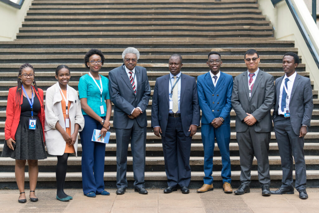 Delegates posing for a group photograph on outdoor steps